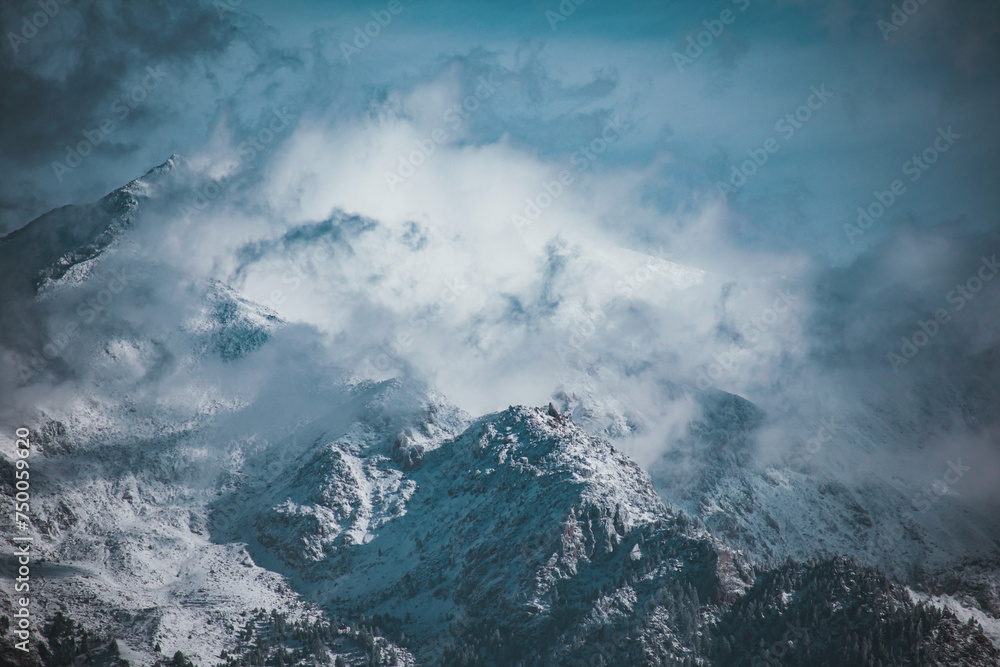 Snowcapped mountains against blue sky.