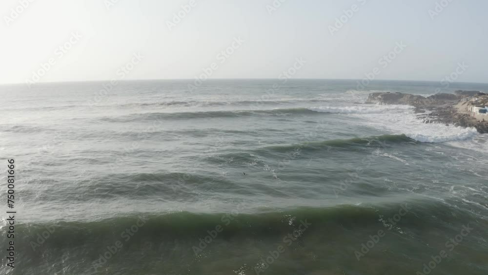 Aerial view of lone surfer at the big waves at Atlantic Ocean, Morocco.. Cinematic shot, 4k. Log recording for better color correction option. Aerial view of lone surfer at the big waves at Atlantic Ocean, Morocco.. Cinematic shot, 4k. Log recording for better color correction option.