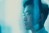 minimalist photo capturing the concentration of Asian data scientists in a modern corporate office, with the soft blue tones of the blurry background adding a sense of tranquility
