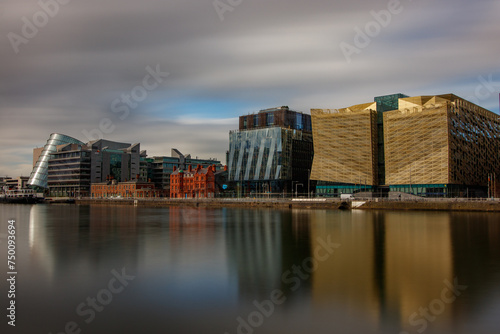 Dublin, Ireland, Dockland, modern building business center cityscape by Liffey river view during sunny day in background. europe