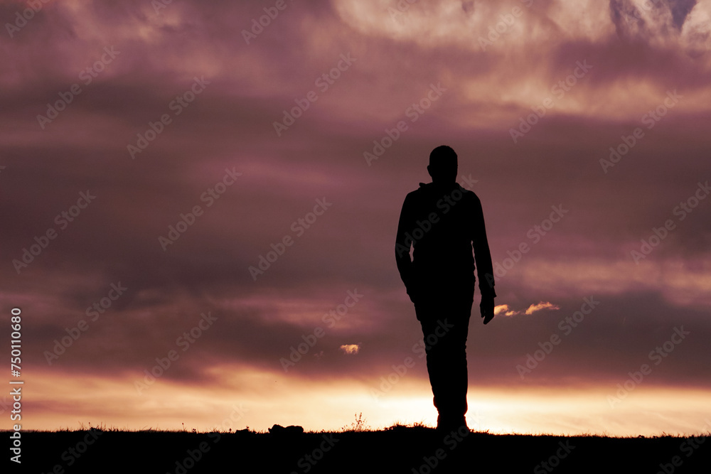 man silhouette in the countryside and sunset background