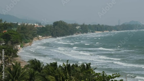 Stormy coast of Khao Tao village with lots of tropical trees in Thailand photo