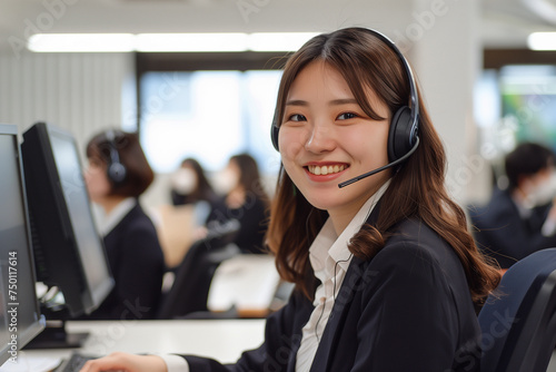 Smiling Customer Service Representative Wearing Headset in Busy Office Environment
