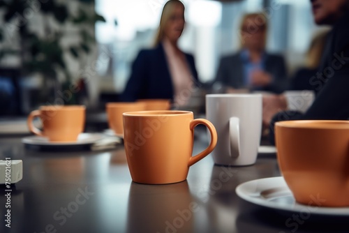 Background of a coffee or tea cup on a desk in the office. in the background blurred with office workers.