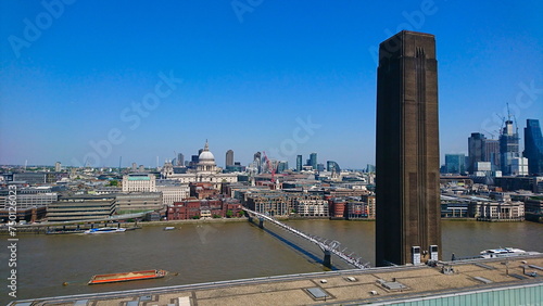 London, UK - 05.15.2018: Skyline from Tate Modern rooftop to the Millennium Bridge and St. Paul's Cathedral under a clear sky photo