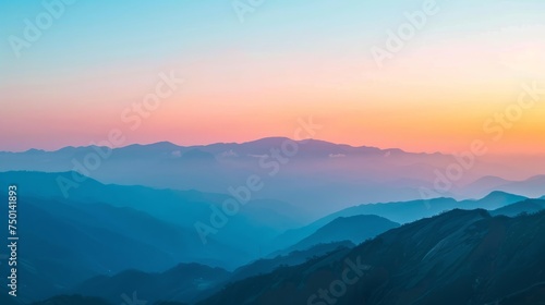 Picturesque panoramic view of mountain range under colorful blue and orange sundown in evening time © Emil