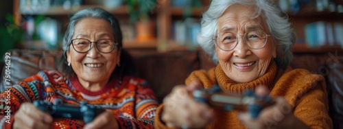 Two elderly women are playing video games with joysticks.  wellbeing, silver generation, age diversity, senior gamers concept.