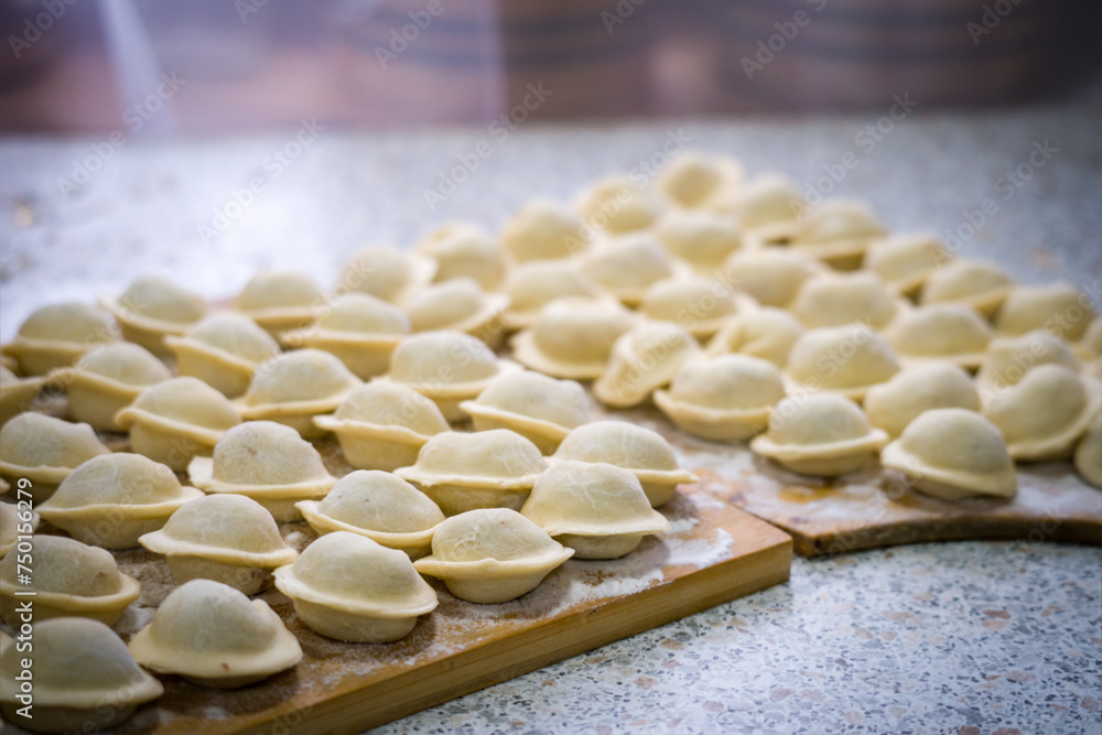Homemade dumplings close-up. handmade dumplings on a wooden board, selective focus, tinted image, traditional Russian dish, Homemade dumplings close-up. handmade dumplings on a wooden board, selective focus, tinted image, traditional Russian dish,