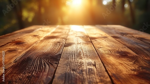 a close up of a wooden table with the sun shining through the trees in the backgrouds of the background. photo