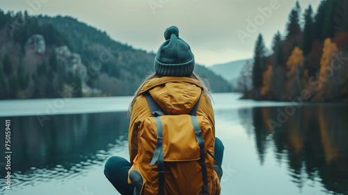 hiker woman sitting at the lake in the nature