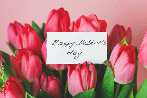bright beautiful bouquet of pink tulips with a gift card with handwritten Happy Mother's Day