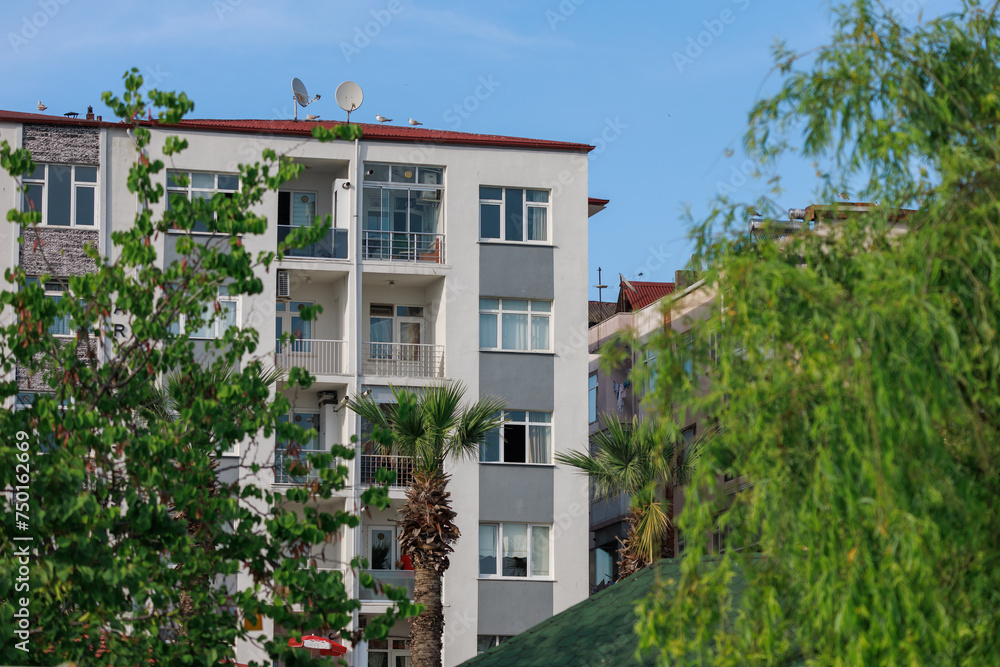 View of buildings and houses in public places in Turkey, sunny summer day