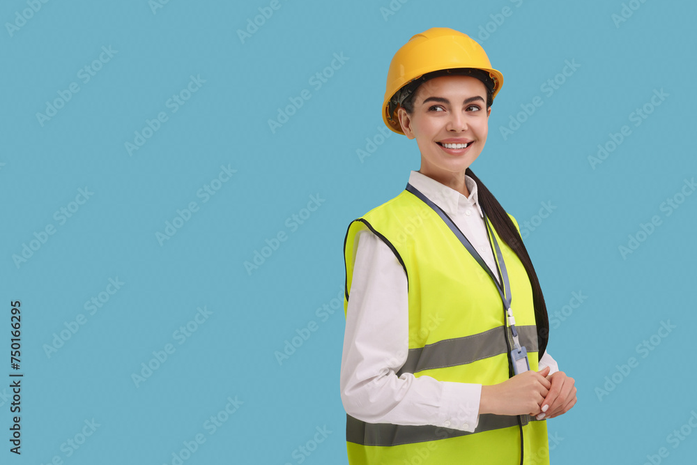 Engineer with hard hat and badge on light blue background, space for text Engineer with hard hat and badge on light blue background, space for text