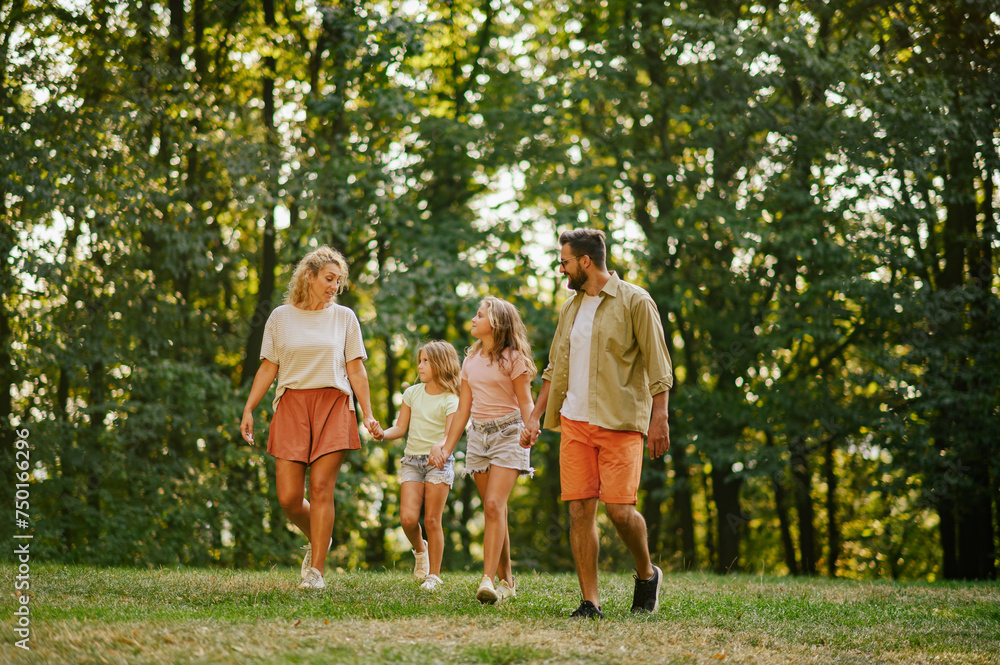 Fototapeta premium A loving family spending time together in forest and taking a walk.