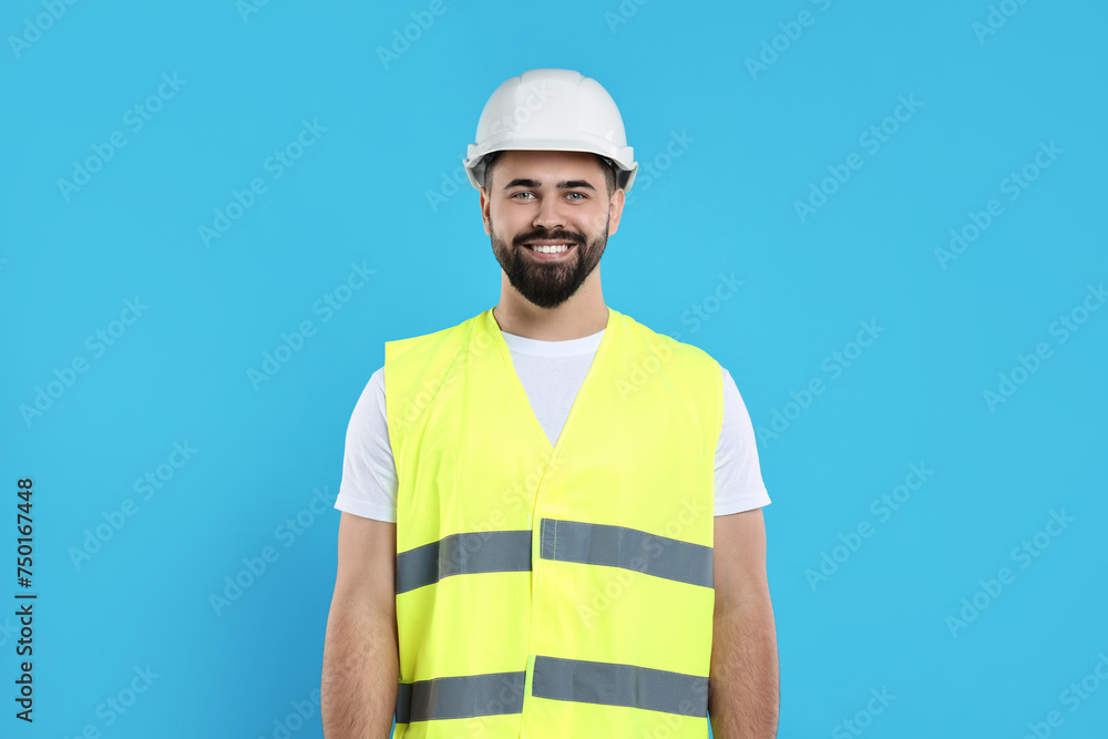 Engineer in hard hat on light blue background Engineer in hard hat on light blue background