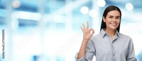 Woman with clean teeth smiling and showing ok gesture on blurred background, space for text. Banner design