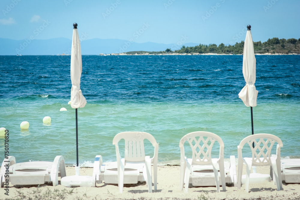 A sun loungers by the sea in nature weekend travel