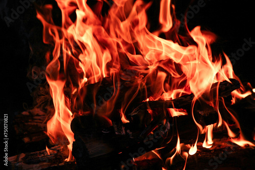 a Fire with coals and fire on nature picnic background. Burns out a bonfire for food on the street