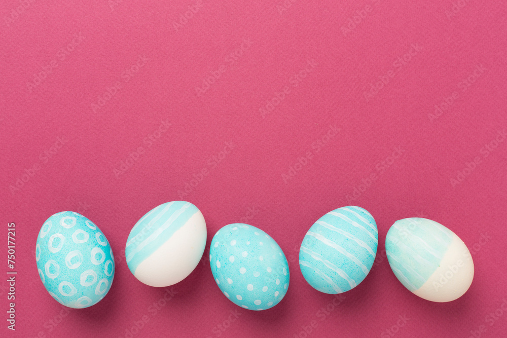 Fototapeta premium Blue easter eggs on color background, top view