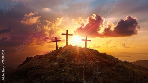 Silhouette of three crosses on a hill with a sunburst behind them