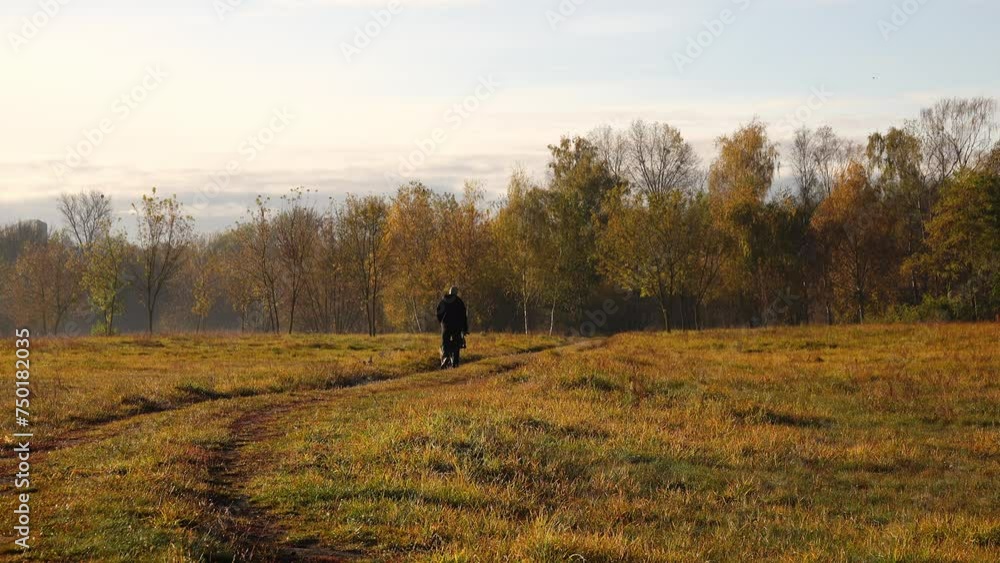 Man and German shepherd walking in autumn city park. Man and German shepherd walking in autumn city park.