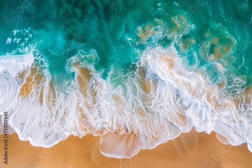 Aerial view of vibrant ocean waves crashing on a sandy beach Capturing the dynamic interaction between sea and land © Bijac