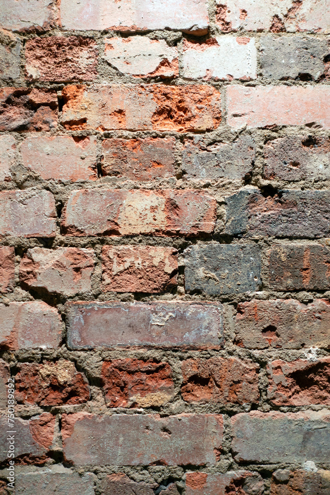 Obraz premium A Crumbling Indoor Vintage Brick Wall with Red Bricks