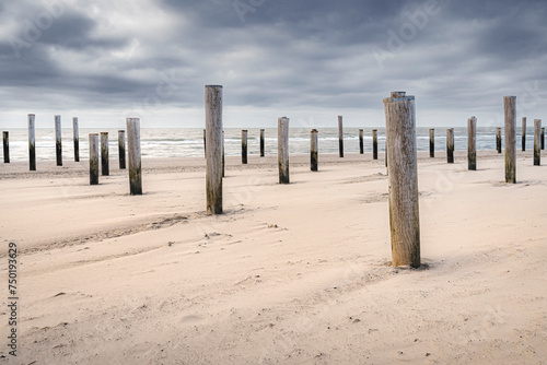 Village of wooden poles at the beach near Petten, the Netherlands