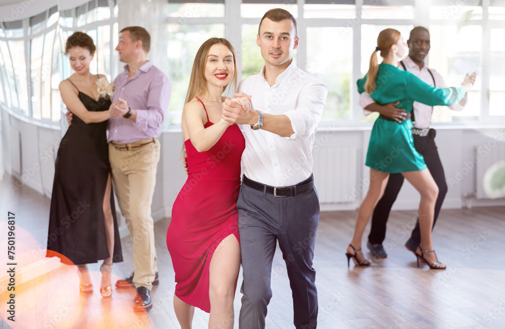 During rehearsal of reporting concert, man and woman participants of dance workshop perform figure waltz. Group training and rehearsal, preparation for competitions