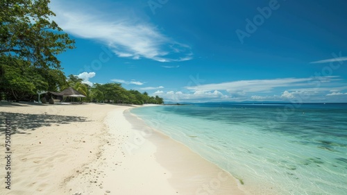 Tropical coastline with clear blue waters - Breathtaking view of a beautiful tropical beach with clear blue waters, white sand and a tranquil beach hut nestled among lush green trees