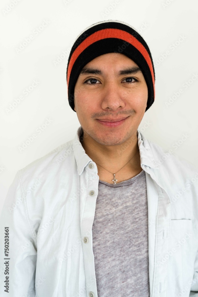 Latin man wearing a beanie on the white background smiling Latin man wearing a beanie on the white background smiling