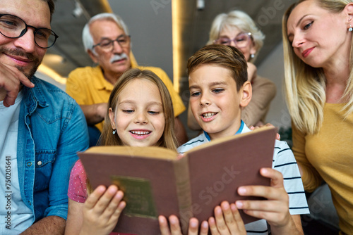 child family portrait woman mother man father grandmother daughter group reading book education girl grandparent generation female grandchild together senior grandfather son boy three