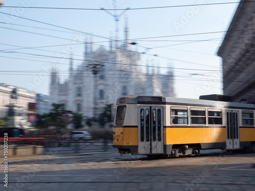 Tram passes quickly in front of Milan Duomo in Piazza Duomo in Milano, Italy, City Traffic blurred motion photography