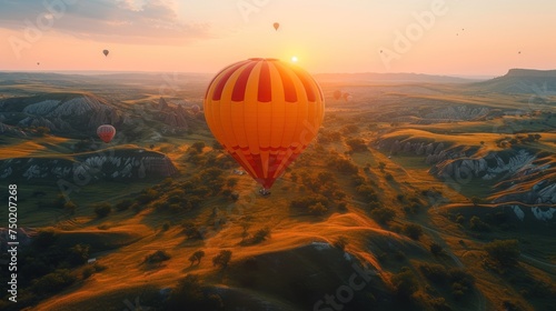 a group of hot air balloons flying over a lush green hillside under a blue sky with the sun rising over the horizon of a valley with trees and mountains in the foreground.