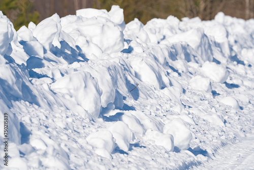 winter landscape, snow-covered field with snowdrifts against the blue sky