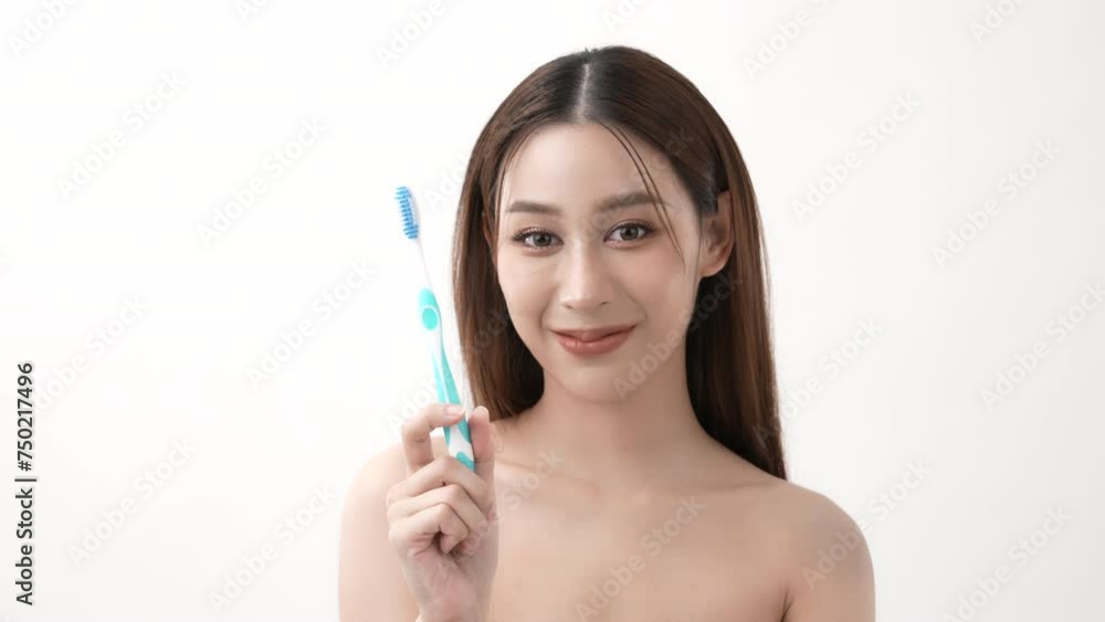 Beauty concept of 4k Resolution. Asian woman with healthy teeth showing toothbrush on white background. Beauty concept of 4k Resolution. Asian woman with healthy teeth showing toothbrush on white background.