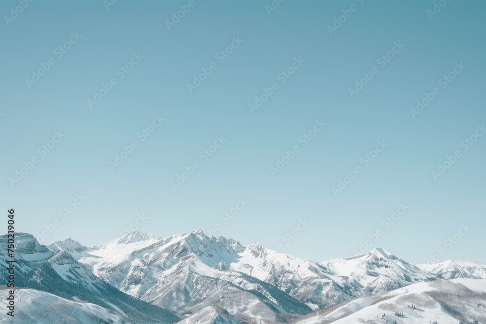 snow-covered mountain range against a clear, blue sky.