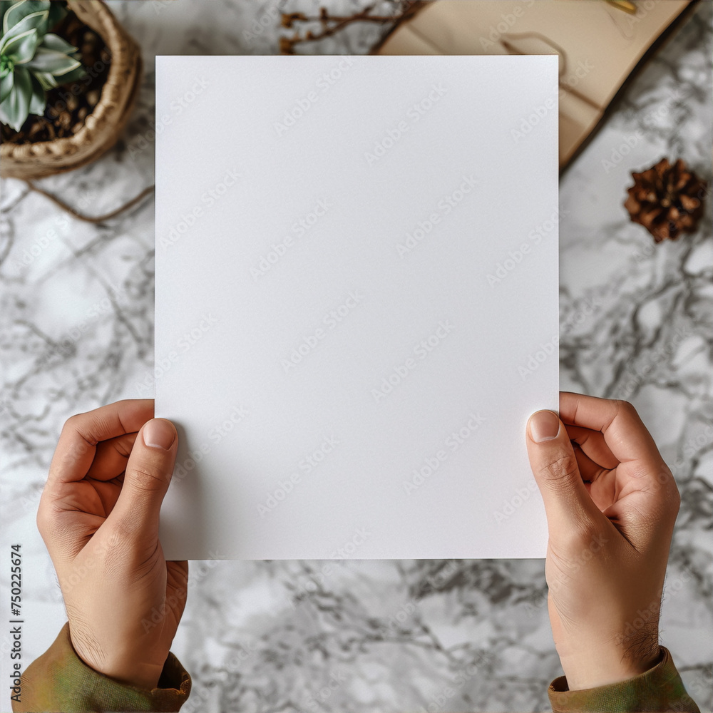 Obraz premium Blank paper in hands over marble background, mockup