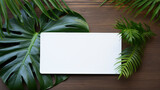 Blank business cards mockup and plant leave monstera on woo den table. Perfect for modern corporate identity stationery. Tropical sophistication.