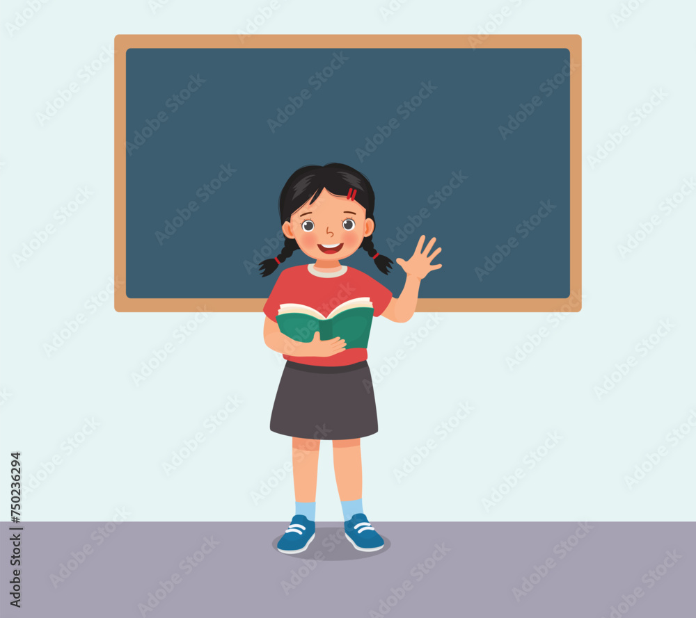 Cute little girl holding book standing in front of class reading speaking Cute little girl holding book standing in front of class reading speaking