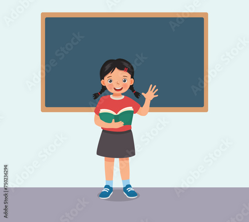 Cute little girl holding book standing in front of class reading speaking