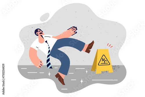 Business man slipped and fell on wet office floor due to clumsiness and unwillingness to look around