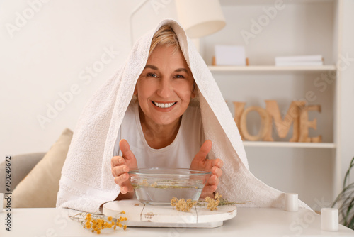 Mature woman with towel doi...