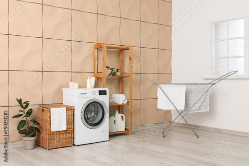 Interior of room with laundry basket, washing machine and dryer