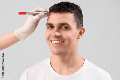 Doctor marking young man's ...