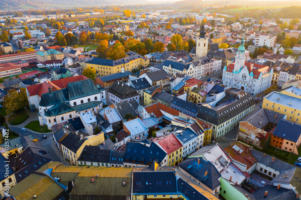 Panoramic aerial view of autumn landscape of Czech town of Sumperk with Church of Saint John Baptist and Town hall at sunrise, Olomouc Region - obrazy, fototapety, plakaty 