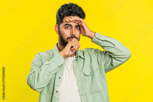 Fotografie Sad young Indian man feeling hopelessness loneliness, nervous breakdown, loses becoming surprised by lottery results, bad fortune, loss unlucky news