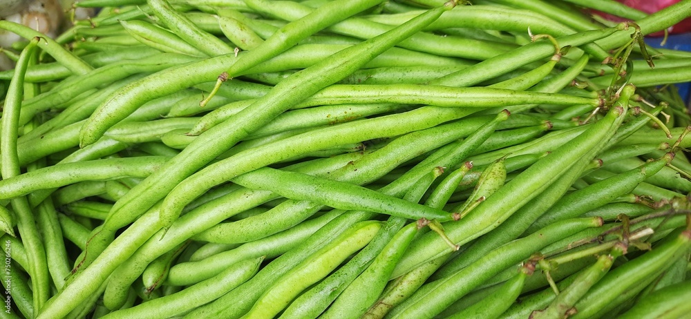 Heap of fresh green beans uncooked. Raw Green Organic French String Beans sold in traditional market Indonesia Heap of fresh green beans uncooked. Raw Green Organic French String Beans sold in traditional market Indonesia