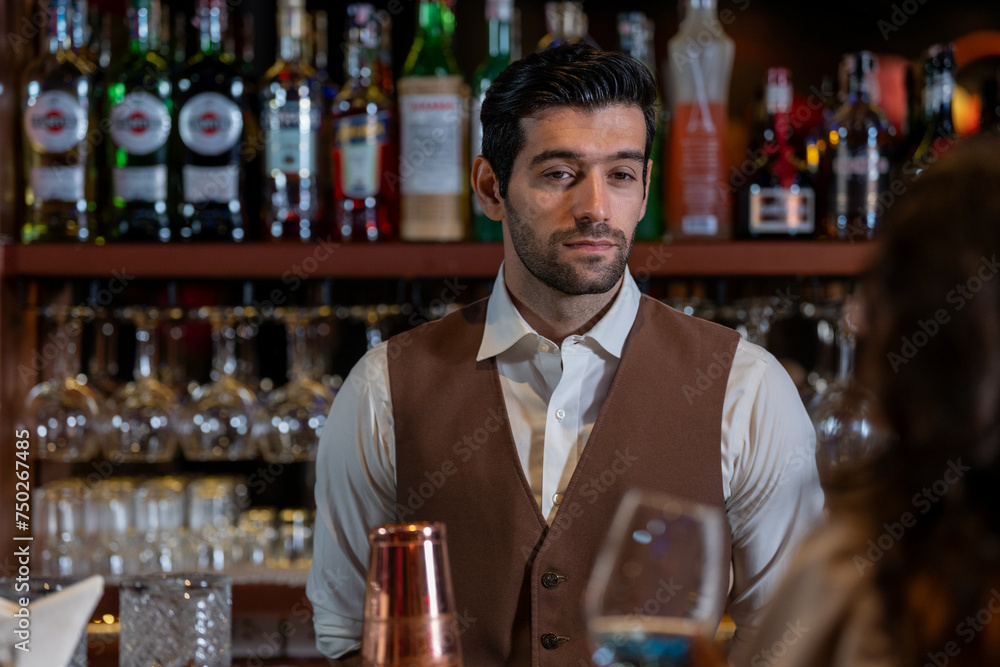 Man bartender is making a drink and dancing at bar. Dance party with group people dancing . Women and men have fun and drinking martini cocktail in night club. Man bartender is making a drink and dancing at bar. Dance party with group people dancing . Women and men have fun and drinking martini cocktail in night club.
