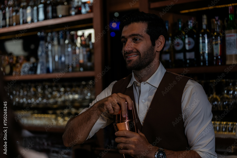 Man bartender is making a drink and dancing at bar. Dance party with group people dancing . Women and men have fun and drinking martini cocktail in night club.